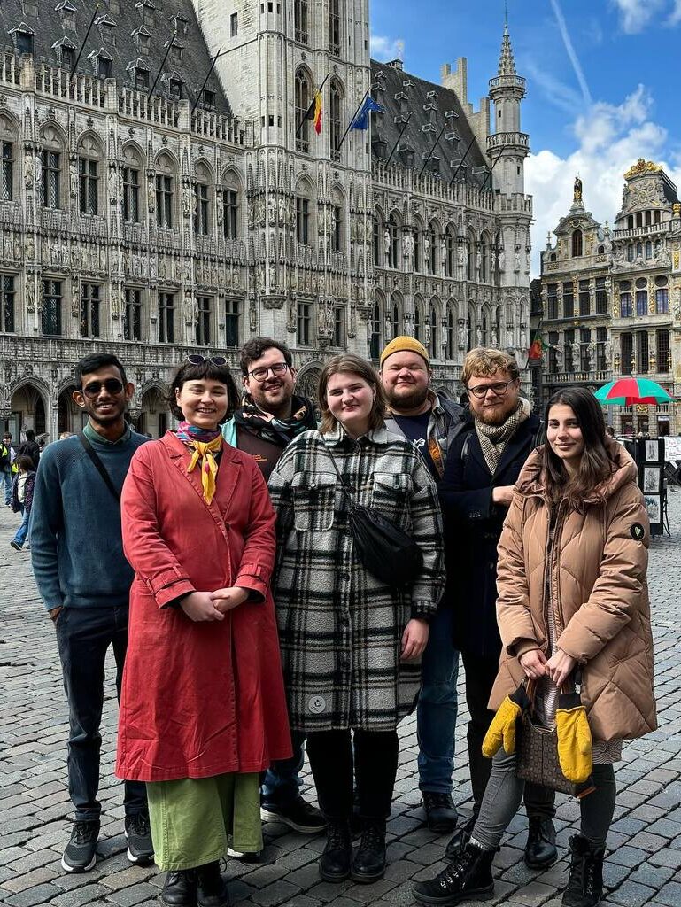 The executive committee posing in Brussels. Alan, Aino, Steven, Saara, Harald, Pavel and Aida are smiling to the camera.